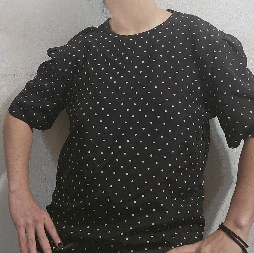 Indulge in timeless elegance with our classic white polka dot blouse.